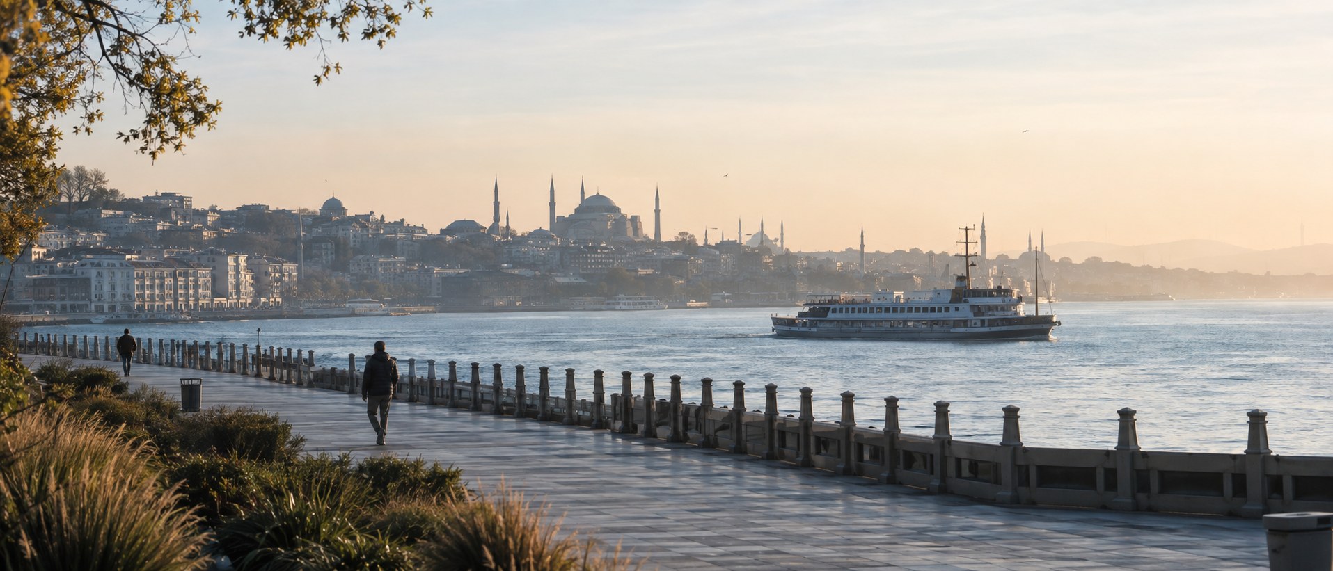 Wide morning view from the Moda coast toward Istanbul's historic peninsula with a ferry crossing the water