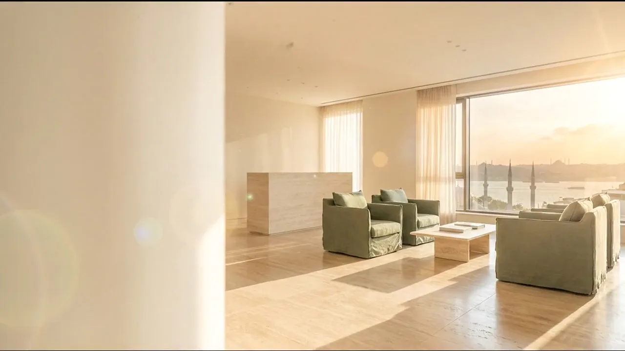 Illustrative film drifting through a quiet clinic interior as afternoon light moves across pale stone
